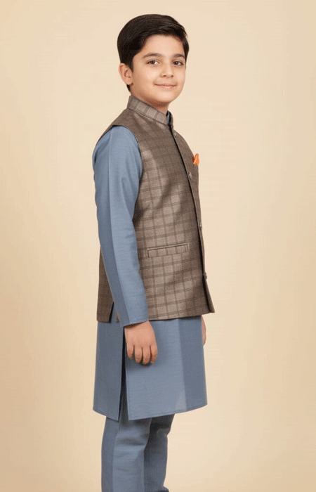 Boys Brown Checked Waist Coat 2 The boy wearing the brown checked waistcoat, facing sideways with a slight smile.