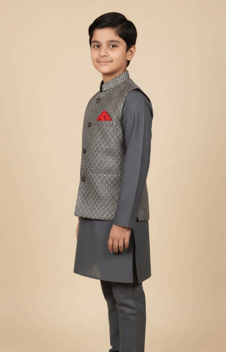 Grey Printed Waist Coat Boys 2 A boy wearing a Grey Printed Waist Coat is standing sideways and smiling, with a red pocket square on the coat.